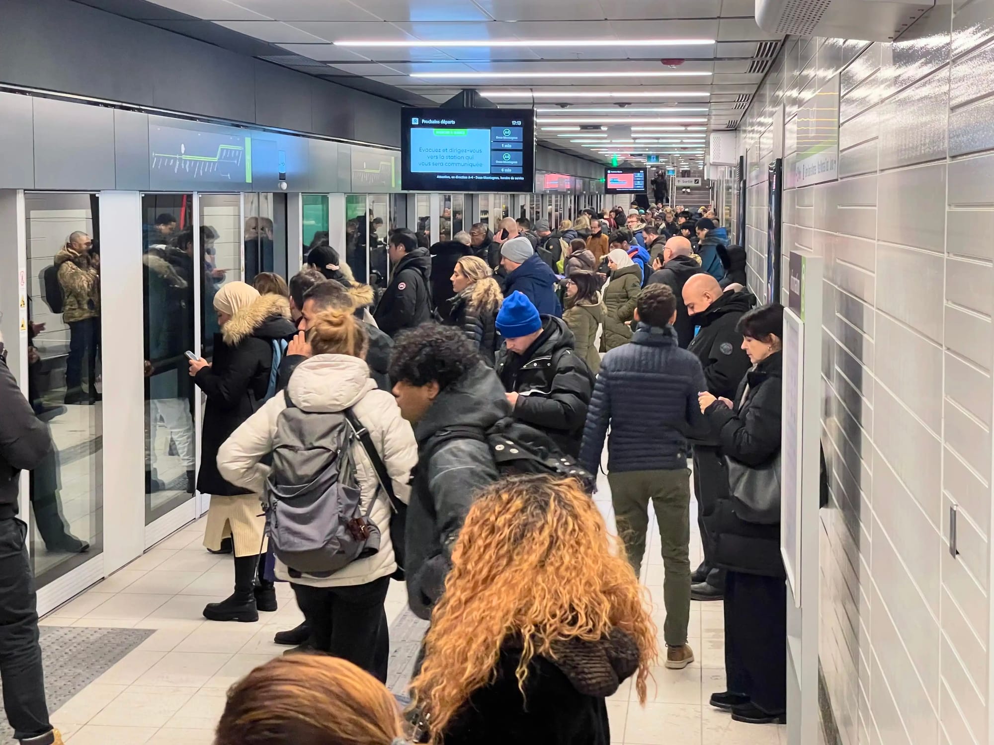 McGill REM station full platform of passengers waiting to board. Heliomass