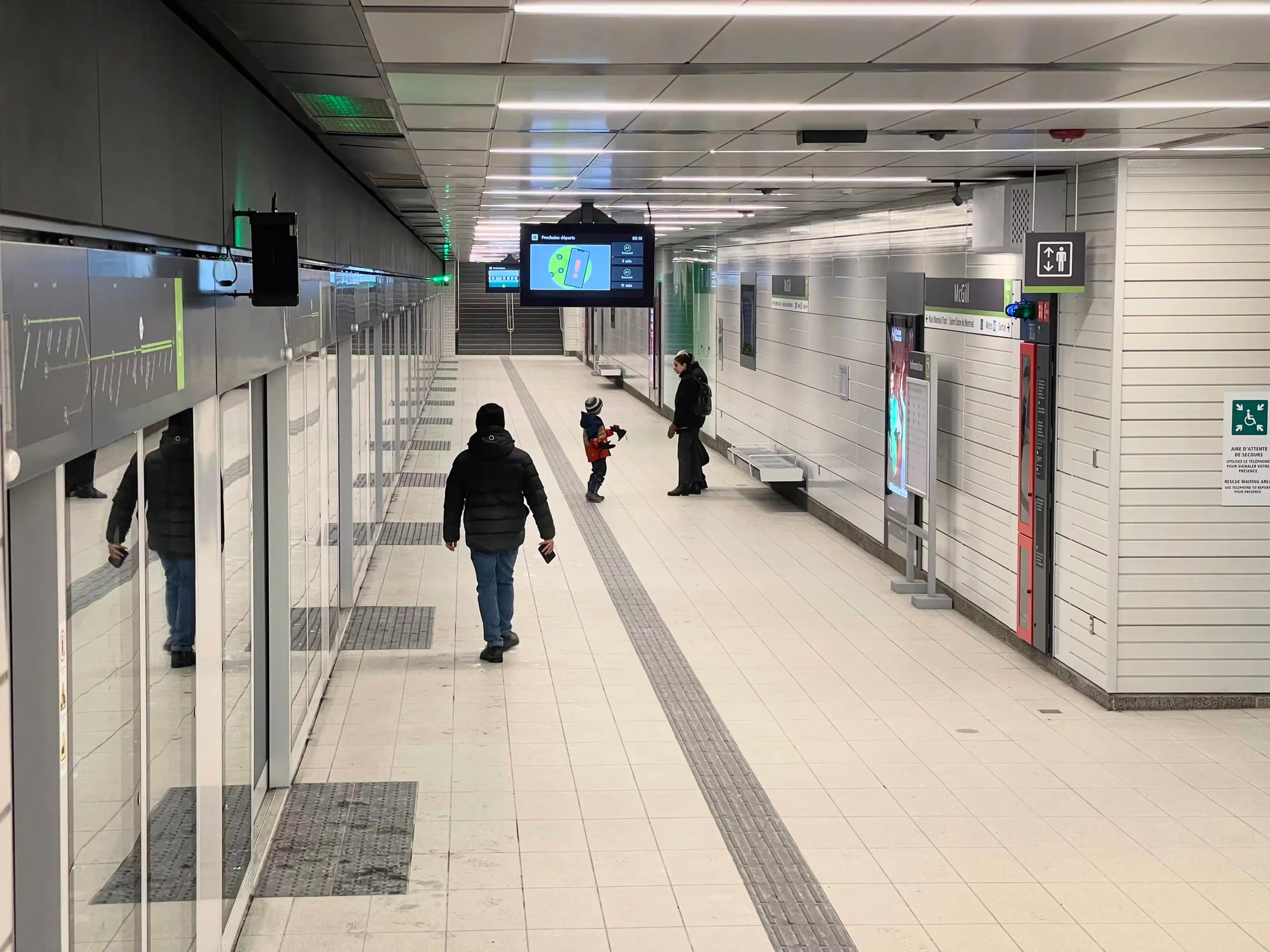 McGill REM station's plain white platform walls. Heliomass
