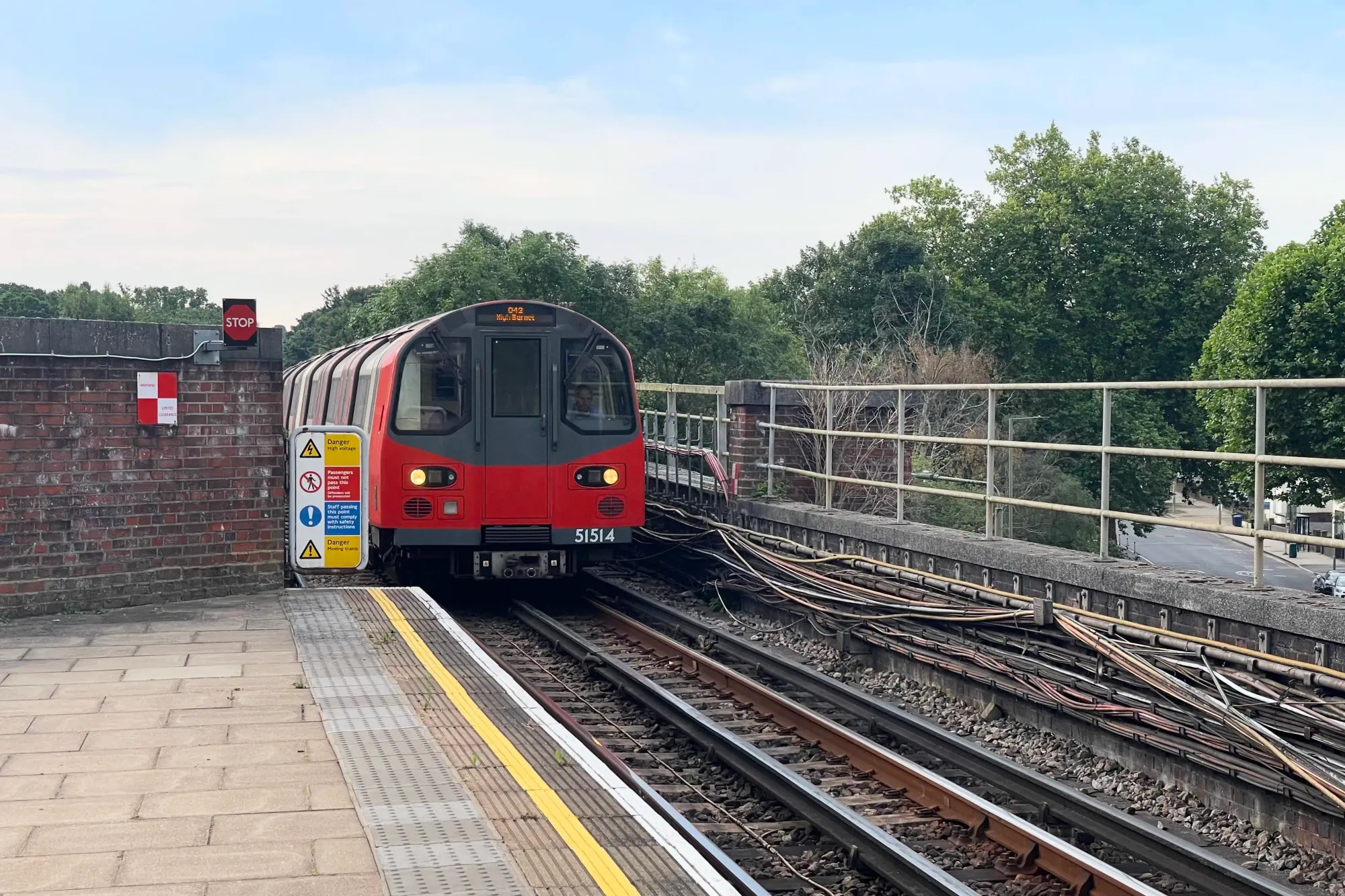 Platform end view of a train approaching from central London, which can be witnessed every couple minutes during rush hour
