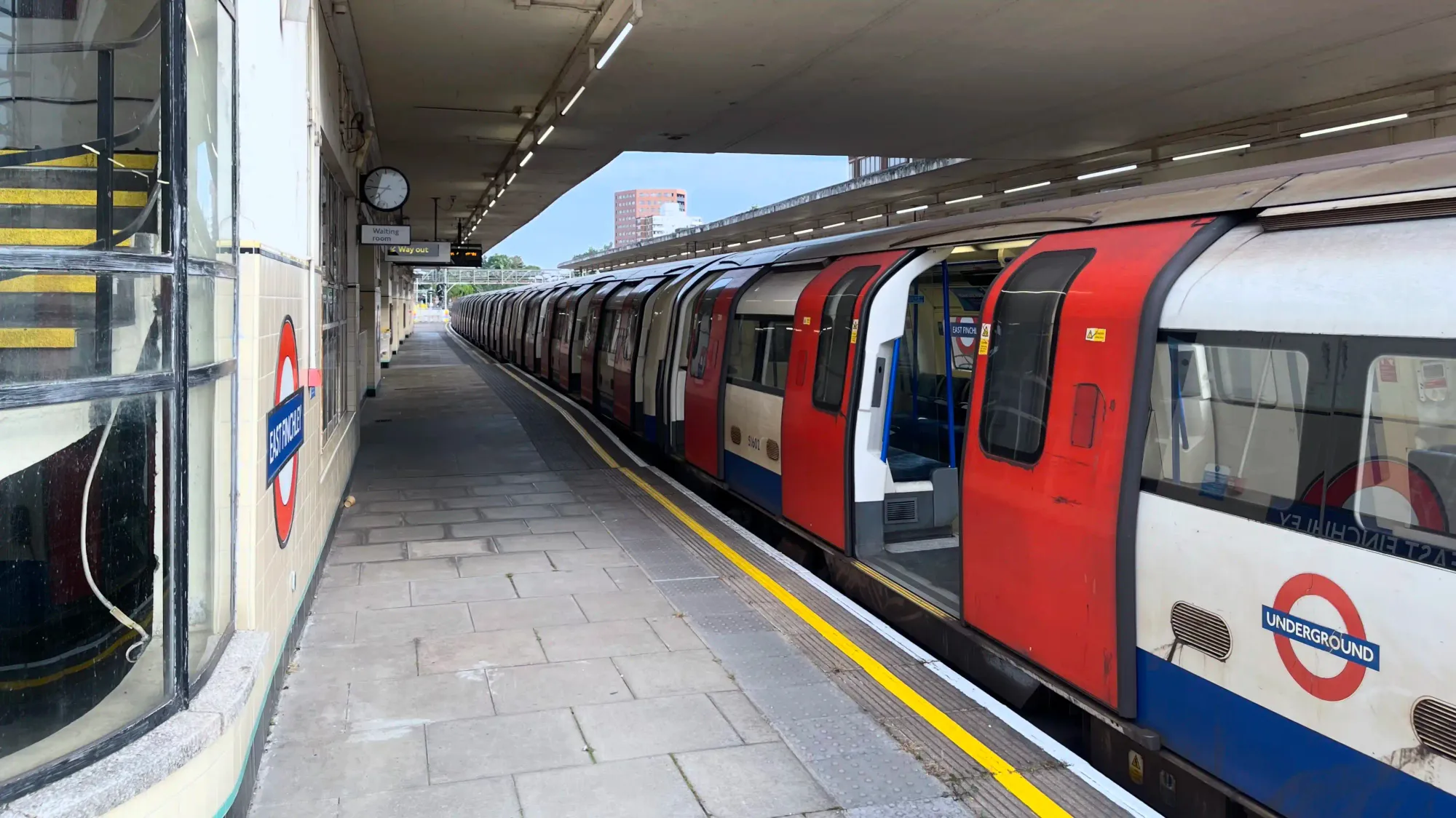A train freshly arrived from Highgate depot waits on one of the middle tracks to travel northbound