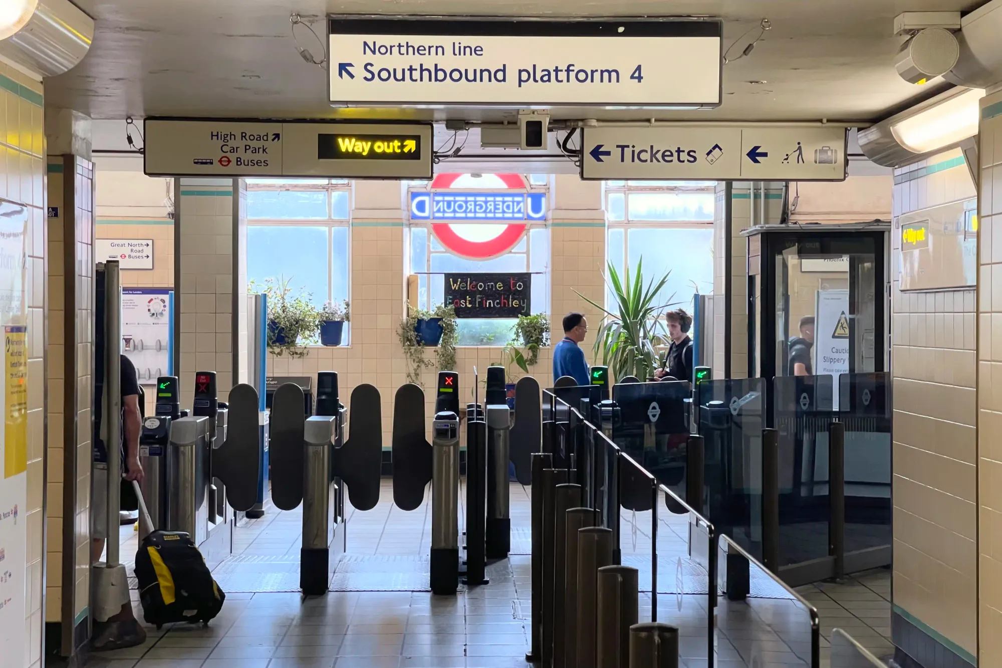 The main entrance ticket gates, with station roundel stained glass window