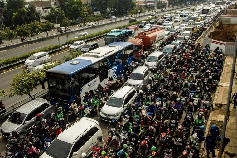 Photo of buses, cars, & motorcycles completely filling a road in Jakarta