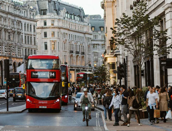 London 94 bus in Central London crowded on street by bike & car, by Dave Hill