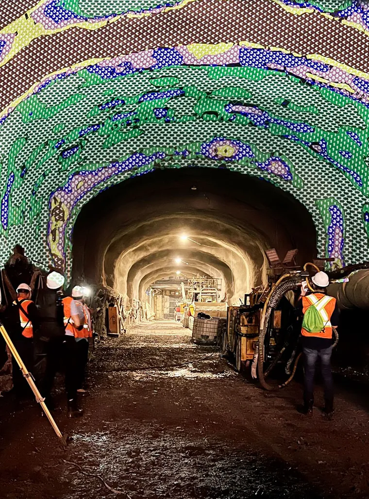 Multi-colour dot patterns projected on raw tunnel ceiling in Montreal.