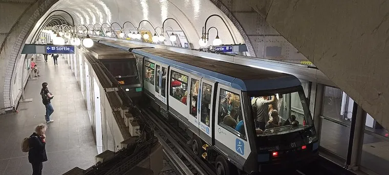 Paris MP89 Metro trains at Cité station, showing platform edge doors & classic French style