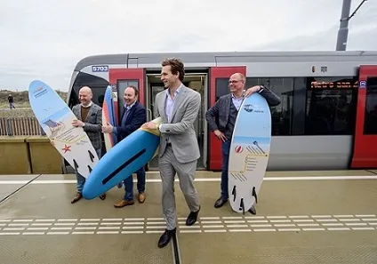 Pic of Rotterdam Metro train with 4 people with surfboards, at extension to the Beach at the Hoek of Holland