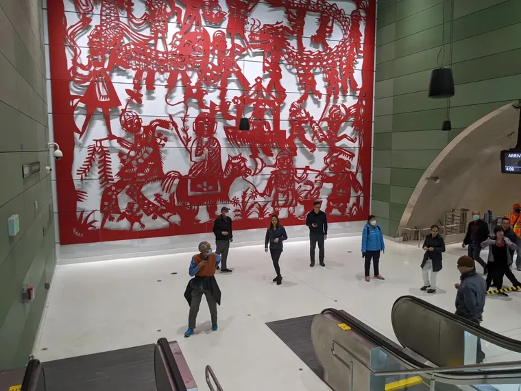 San Francisco's new Central Subway Chinatown station interior with large red screen