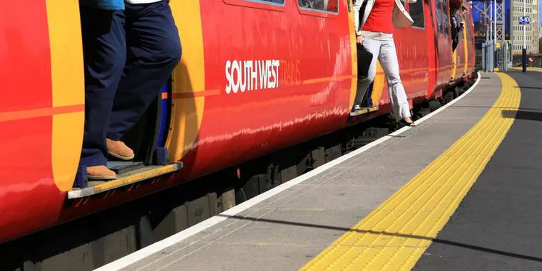 Passengers stepping off train at Vauxhall station with large vertical & horizontal gap. Network Rail photo