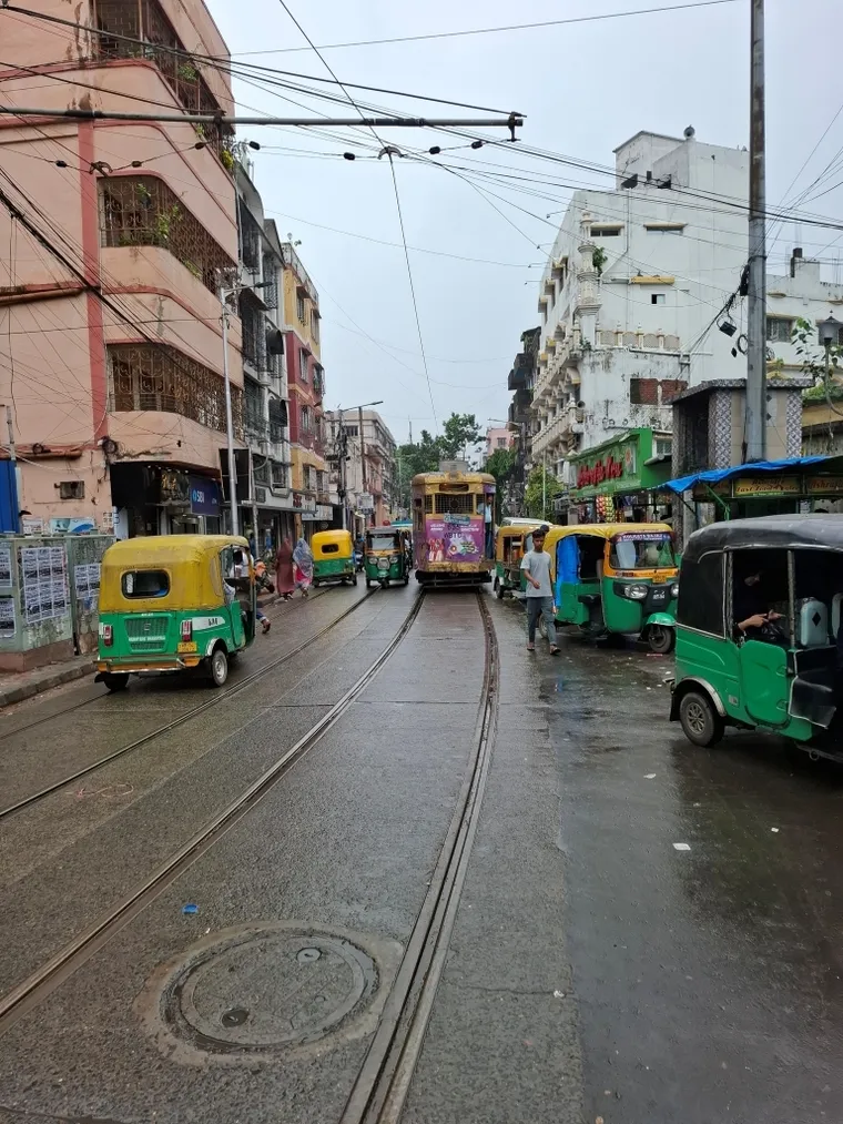 Old Kolkata tram in busy street full of auto rickshaws. Dirk Budach