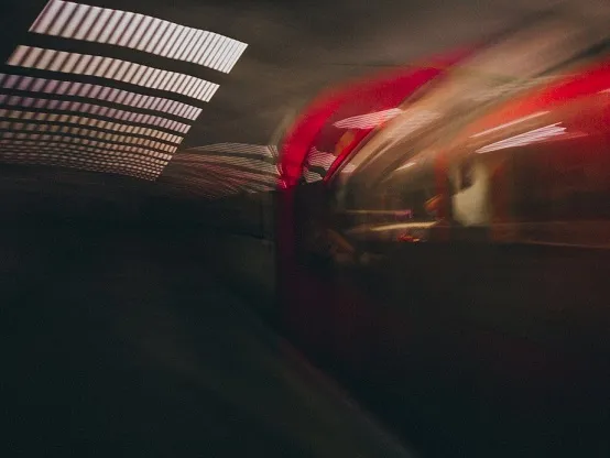 Underground is a blur - blurred photo of a Tube train in a station, with a light grill reflexion. Author