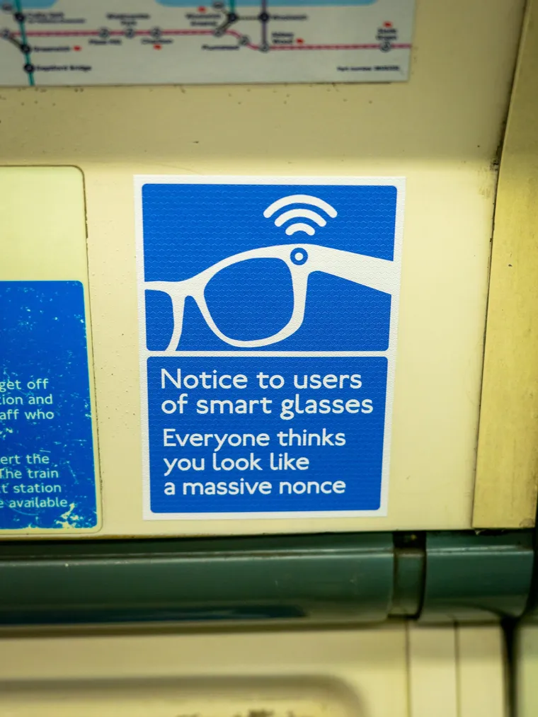Spoof blue TfL public Smart Glasses wearers look like a Massive Nonce service notice by Everyone Hates Elon, via Famous Campaigns